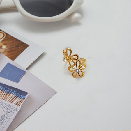 Gold Flower Zircon Rings Set of 5 Adjustable Non Tarnish Titanium Steel Jewelry for Women - A detailed flat-lay view of the Gold Flower Zircon Ring Set, showcasing the delicate floral design and sparkling zircon stones on a gold-tone titanium steel band.