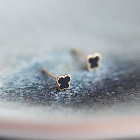 Detailed view of the 925 sterling silver butterfly stud earrings with black enamel finish.