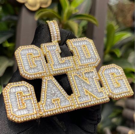 Bold 'GOLD GANG' custom pendant, fully iced out for maximum impact.