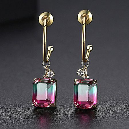 Angled shot of the gold gradient gemstone earrings, emphasizing the lever-back finding and square-cut stone.