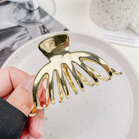 Metal Pumpkin Shape Ponytail Anti-Slip Hair Clips for Women - A close-up product shot of a stylish gold metal hair clip in a unique pumpkin shape, displayed on a clean white background.