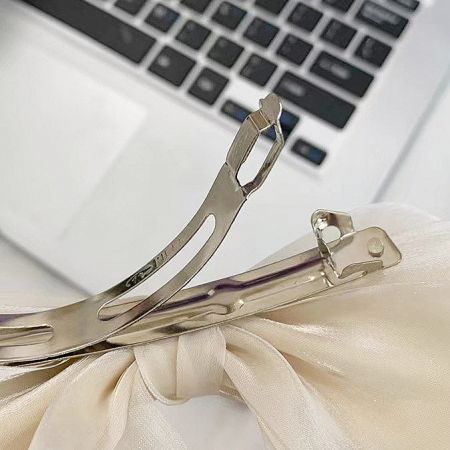 Back view of the hair clip showing the gold spring clip mechanism.