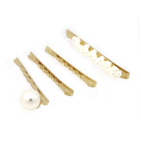 Detailed shot of the gold hair clips highlighting the intricate pearl decorations.