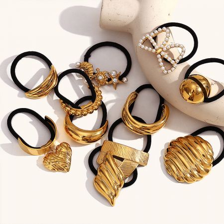 A collection of five ocean-themed stainless steel hair ties in gold finish, displayed together.