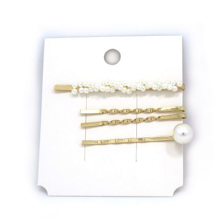 Another angle of the elegant gold hairpins with classic pearl details.