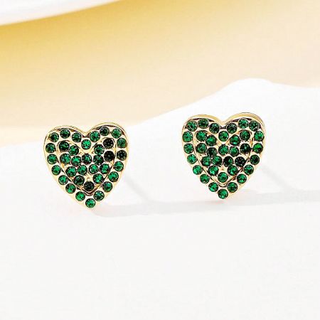 An angled perspective of the waterproof gold heart earrings, showing their brilliant shine and color.