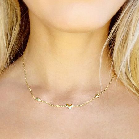 Another view of the heart necklace on a model.