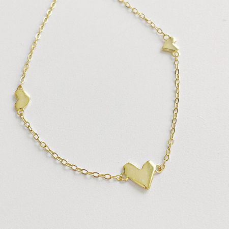 Studio shot of the gold heart charm necklace.