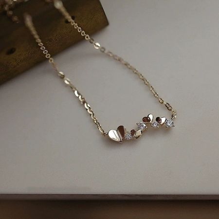 Another angle of the gold heart necklace highlighting the brilliant cubic zirconia.