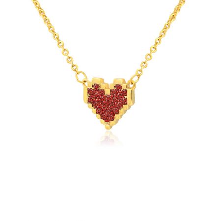 Angled view of the gold heart necklace showcasing the sparkling red gemstones.