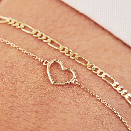 Detailed view of the gold 925 sterling silver heart bracelet on a wrist.