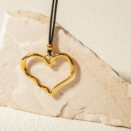 Another view of the gold heart pendant, highlighting its shine.