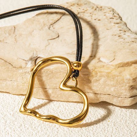 Promotional shot of the gold heart pendant jewelry.