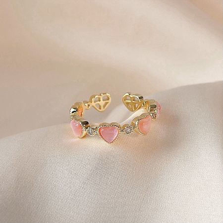 Matching gold bracelet with pink heart-shaped stones, part of the collection.