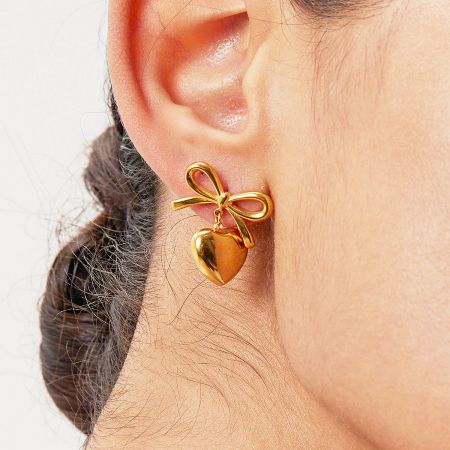 Stainless Steel French Knot Bow Heart Drop Earrings (5 Pairs) - Close-up of a stainless steel French knot bow heart drop earring in a gold finish, showcasing the intricate bow and heart design.