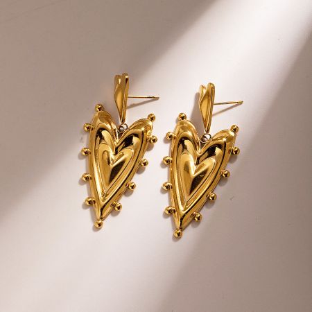 Close-up view of the double-layered heart design on the gold PVD earrings.