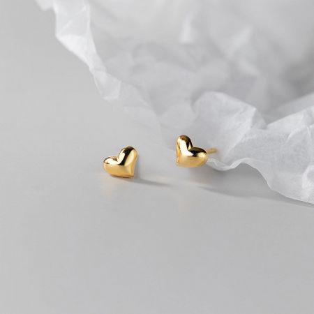 A pair of gold 925 sterling silver mini heart stud earrings.