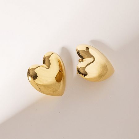 A pair of gold heart-shaped stud earrings on a white background.