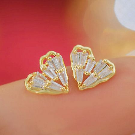 A pair of elegant heart-shaped earrings with sparkling clear gemstones.