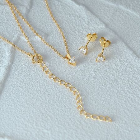 The complete gold heart jewelry set, necklace and stud earrings.