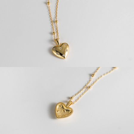 Two gold heart-shaped necklaces showing variations in design and detail.
