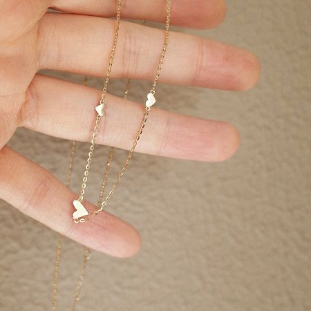 S925 Sterling Silver Triple Small Heart Necklace (Set of 5) - A detailed view of the S925 Sterling Silver Triple Small Heart Necklace, showcasing its delicate triple-heart pendant design in a radiant gold finish.