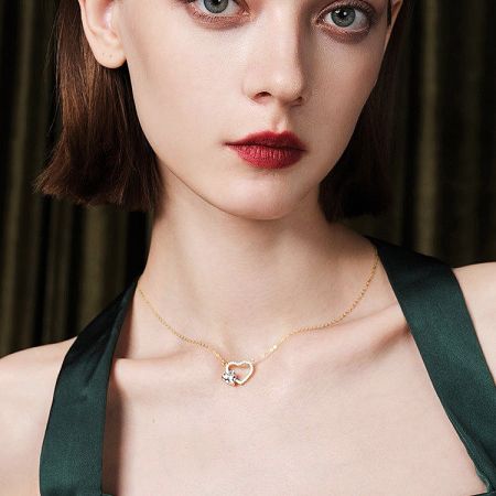 Angled shot of the 925 sterling silver hollow heart necklace.