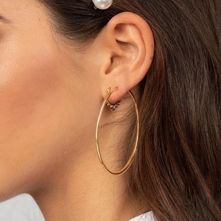 Example of the gold hoop earring customized with a small charm.