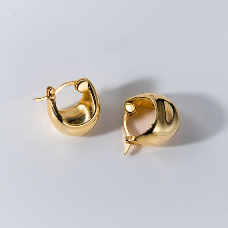 A pair of minimalist gold hoop earrings with a modern geometric design.