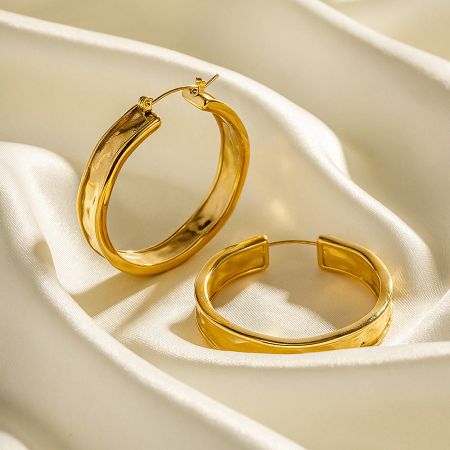 Close-up view of the gold hoop earrings' secure hinged closure.