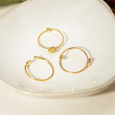 Three distinct designs from the adjustable ring set, displayed on a white plate.