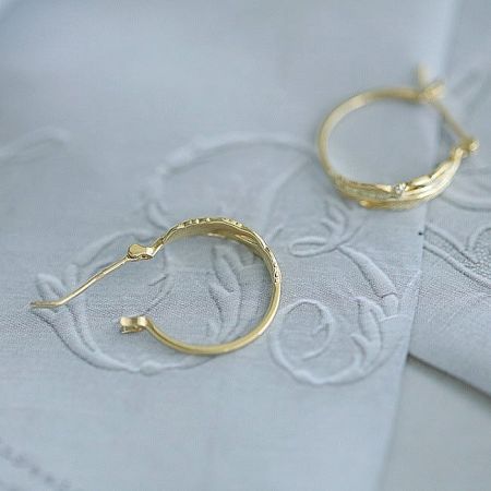 Full set of the 14K gold plated feather leaf hoop earrings displayed.