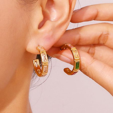 Model showcasing the elegant gold bamboo hoop earrings with clear and green zircon stones.