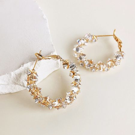 Another angle of the gold-plated hoop earrings with clear crystals.
