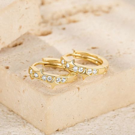 Gold variant of the star zircon hoop huggie earrings.