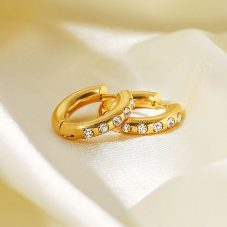Elegant gold hoop earrings featuring classic white cubic zirconia for a timeless look.