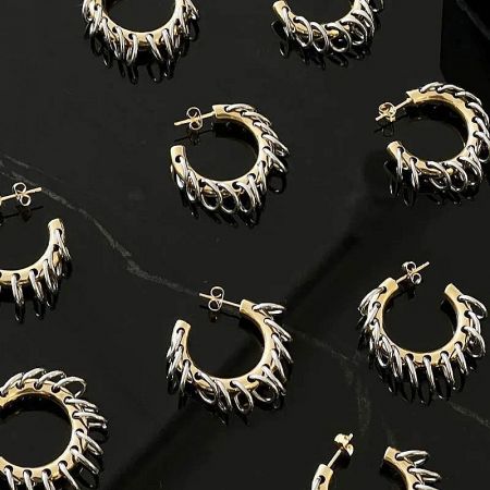 A collection of the stainless steel punk hoop earrings laid out to display the unique design and craftsmanship.