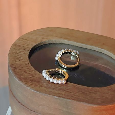 Another design from the five-pair set of gold hoop earrings with pearls.