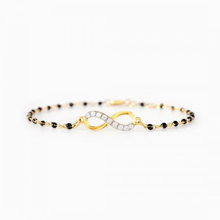 Full view of the Infinity of Hope bracelet, displaying the contrast between the gold charm and black beads.