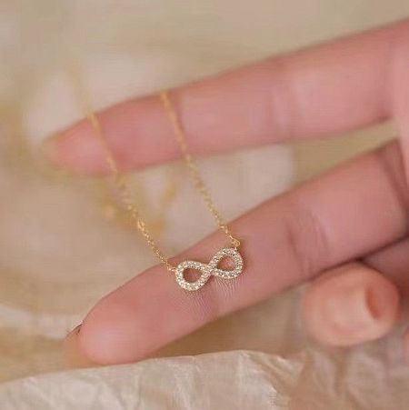 925 Sterling Silver Infinity Pendant Necklace with Cubic Zirconia - A close-up of the elegant 925 sterling silver infinity pendant necklace in a radiant gold finish, showcasing the sparkling cubic zirconia stones.