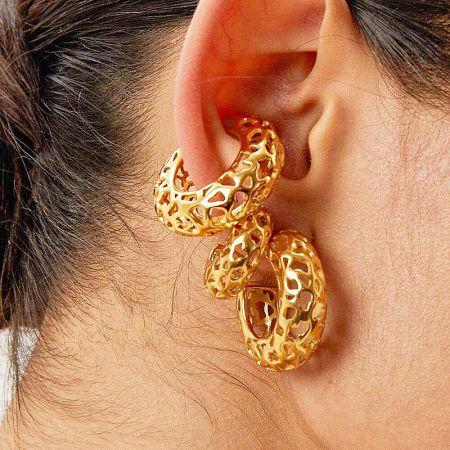 Detail of the textured surface on the interconnected hoop design of the ear cuff.