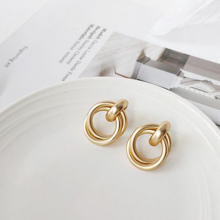 Angled view of the stylish geometric knot cord stud earrings, showing their unique shape.