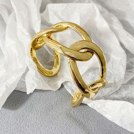 An elegant gold cuff bracelet featuring a sophisticated intertwined design.