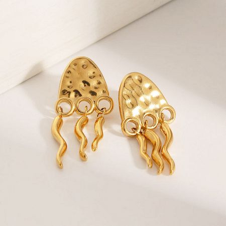 Detailed view of the gold jellyfish stud earrings showcasing the textured surface and intricate tentacles.
