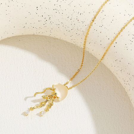 A variation of the gold jellyfish pendant featuring a pearl body and gemstone-tipped tentacles.