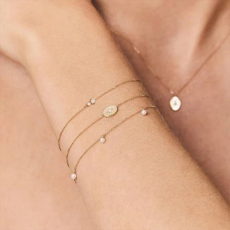 An assortment of star-themed gold jewelry including bracelets and a necklace.