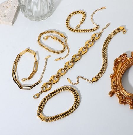 A collection of custom gold plated jewelry including bangles and necklaces by JR Fashion Accessories.
