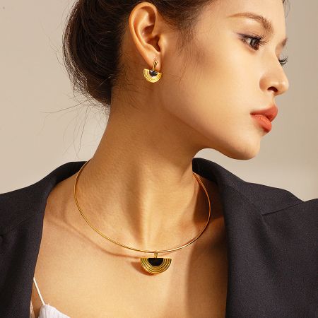 A complete set of the 18K gold plated stainless steel necklace and earrings with Egyptian fan-shaped pendants.