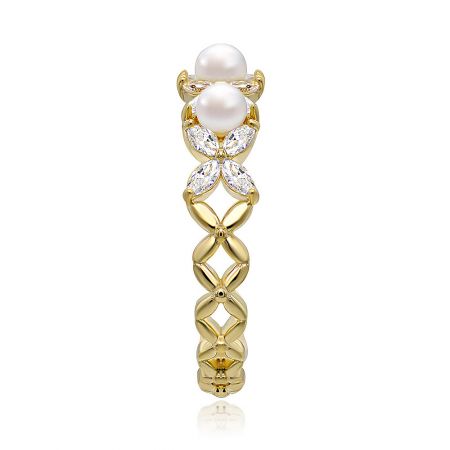 Angled shot of the gold-plated ring, showing the arrangement of pearls and CZ stones.