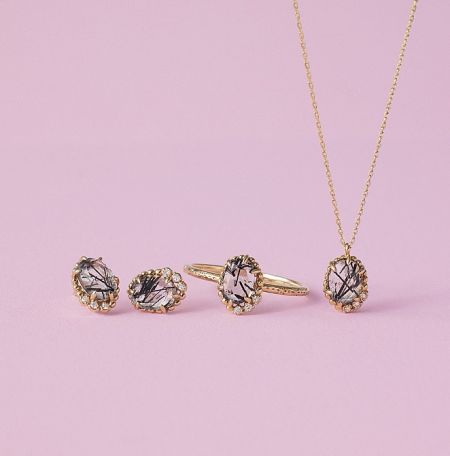 A matching jewelry set including the salt and pepper gem stone ring, showcasing its unique black inclusions.